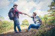 © EKKAPON - Young attractive couple hiking in the forest.