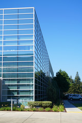 Wall Mural - close up on modern company building exterior with blue glass