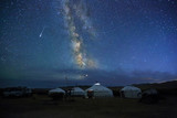 Fototapeta  - Night scene of the Milky Way over Mongolian yurts,Western Mongolia
