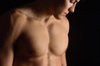 © curto - naked breast of a man on black background
