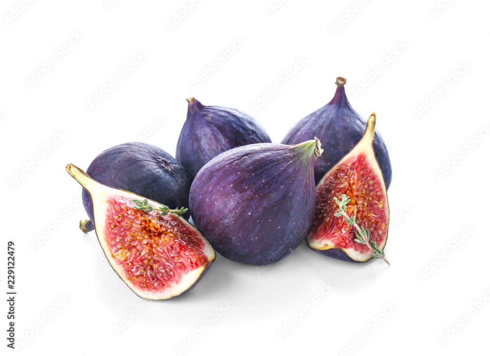 Whole and cut purple figs on white background