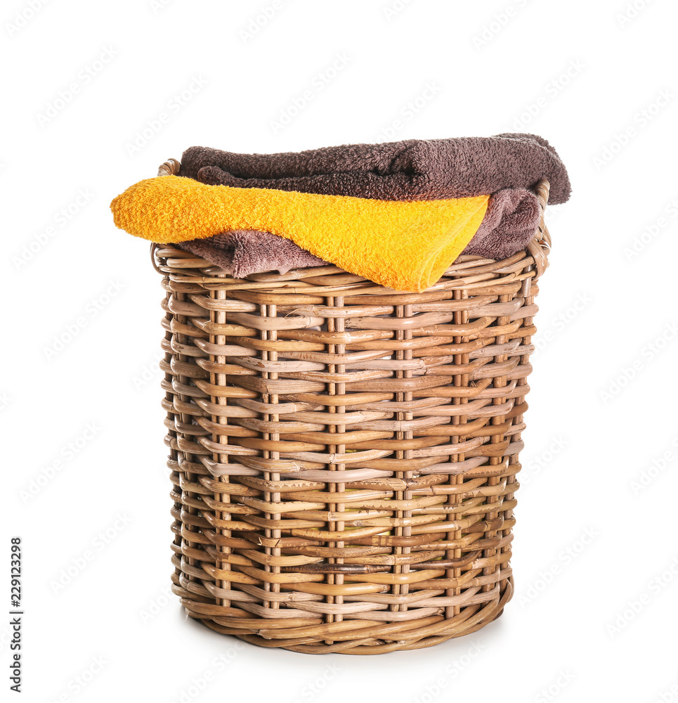 Basket with clean soft towels on white background