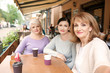 © Pixel-Shot - Beautiful mature women taking selfie in cafe