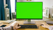 First Person View of Professional Freelancer Working on Green Mockup Screen Personal Computer From Home. Close-up POV Shot. In the Background Cozy Living Room.