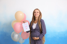 Beautiful Pregnant Woman With Card And Air Balloons On Color Background