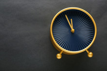 Golden Alarm Clock On Black Background