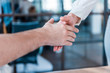 © LIGHTFIELD STUDIOS - cropped shot of business partners shaking hands in office