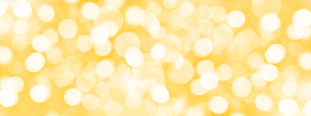 holiday golden panoramic background with blurred bokeh lights