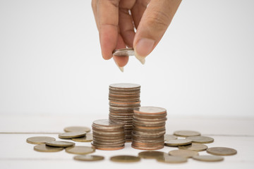 Hand and thai coin on the white background