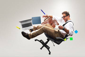 Wall Mural - Young male employee falling from the chair