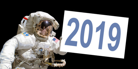 Wall Mural - astronaut in space holding a 2019 white board - elements of this image are provided by nasa