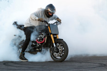Biker Staying On The Bike, Burning Tire And Creating Smoke On The Motorcycle Show