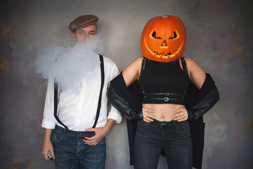 Poster - Unusual couple at Halloween party, Woman with pumpkin on head