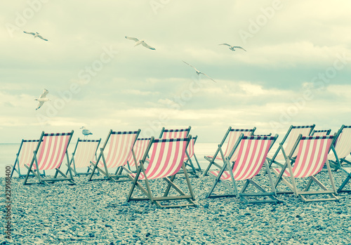 Striped Deck Chairs On English Beach With Seagulls Buy - 