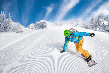 Man snowboarder riding on slope.