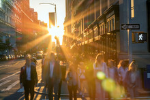 Crowd Of Blurred People Crossing A Busy Intersection On 5 Th Avenue In New York City With The Bright Light Of Sunset In The Background