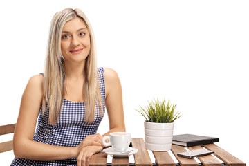 Wall Mural - Blond female sitting at a coffee table