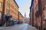 Fototapeta  - Street in the Historic Mining District of Nikiszowiec in Katowice in Polish Silesia. The street is adjoined by  red-brick houses in which the miner's family lived
