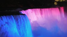 The Colorful Niagara Falls At Dusk, Brightly Illuminated By Spotlights