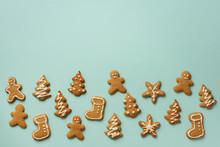 Christmas Handmade Cookies On Blue Background With Copy Space. Pattern Of Gingerbread Men, Snowflake, Star, Fir-tree, Boot Shapes. New Year Concept