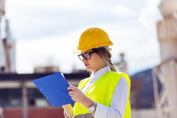 Female industrial engineer with clipboard