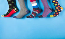 Five Different Men's Socks In A Row On A Pastel Blue Background, Concept