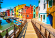 Venice landmark, Burano island canal, bridge, colorful houses and boats, Italy.