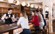 © JackF - Portrait of barman and people who are standing near bar counter in luxurious restaurant