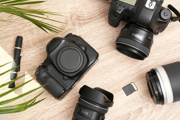 Wall Mural - professional photographer's equipment on wooden table, top view