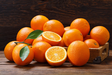 Wall Mural - fresh orange fruits in a box on wooden table