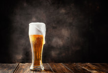 Glass Of Fresh And Cold Beer On Dark Background