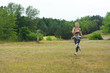 © Demian - Woman running in green park on summer day