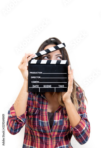 Fotografia, Obraz Smiling woman face covered holding film slate waist up looking right