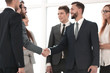 © ASDF - Business partners shaking hands as a symbol of unity