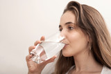 Fototapeta Łazienka - woman drinking a glass of water