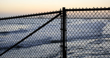 Background Plate Of Silhouetted Chain-link Fence In Front Of A California Beach