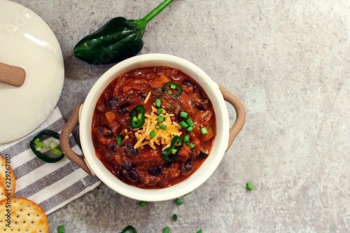 Fotografie, Obraz Homemade Vegetarian Bean Chili with crackers, overhead view