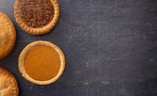 Holiday Table Set With Various Flavors Of Fresh Baked Pies