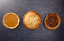 Holiday Table Set With Various Flavors Of Fresh Baked Pies