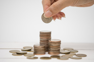 Hand and thai coin on the white background