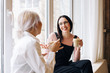 © VISUALSPECTRUM/Stocksy - Two Women Chatting Over Coffee