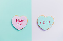 Pale Valentine Candy Cookies With Messages Over Pastel Background