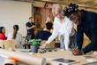 © VISUALSPECTRUM/Stocksy - Corporate Teamwork - Group of Young People Working Together in B