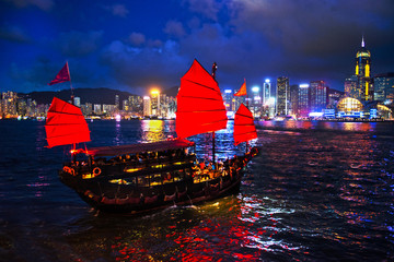 Wall Mural - Victoria Harbour Hong Kong night view with junk ship on foreground