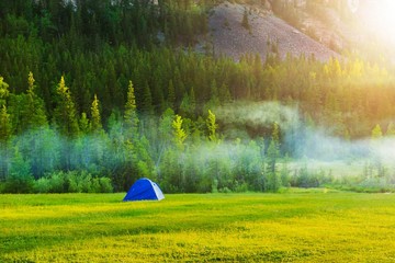 Wall Mural - Tourist tent at the foot of the mountains