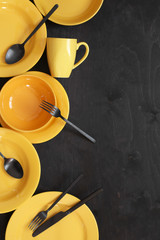 Poster - Yellow tableware on black wood