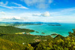 View of tropical island Langkawi in Malaysia, covered with tropical forests. Aerial view on the bay, marina and archipelago of smaller islands in Andaman sea.