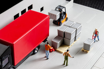 miniature warehouse workers forklift carrying goods box to semi truck with trailer .logistics warehouse freight transportation concept