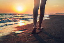 Walking On The Beach In Sunset Time