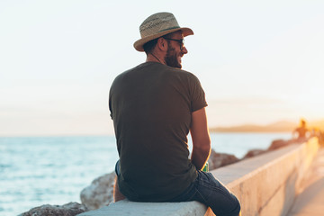 Wall Mural - Man enjoying the sunset in the harbor